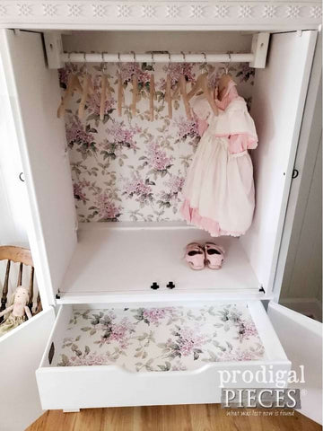 Upcycled entertainment center that's been turned into a nursery wardrobe