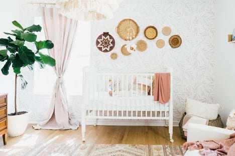 A vintage style nursery with a collection of round art pieces displayed on the wall