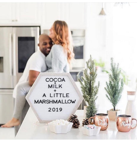 A letterboard that says "Cocoa Milk and A Little Marshmallow 2019" used in a winter pregnancy announcement