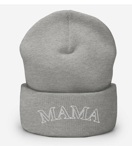 A knit hat that says MAMA used in a winter pregnancy announcement