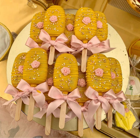 Cake pops decorated like Belle's gold dress from Disney's "Beauty and the Beast"