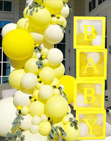 Bright yellow balloon display and "Baby" sign