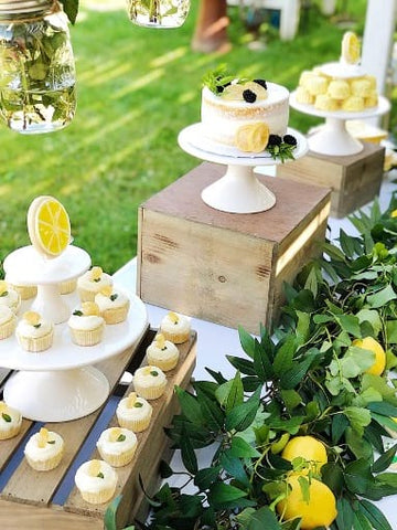 Cakes and cupcakes decorated with frosting lemons for a baby shower
