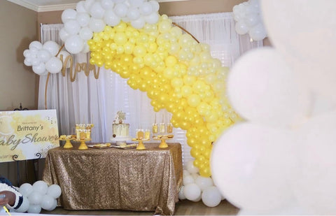 Rainbow balloon arch made with balloons in shades of yellow