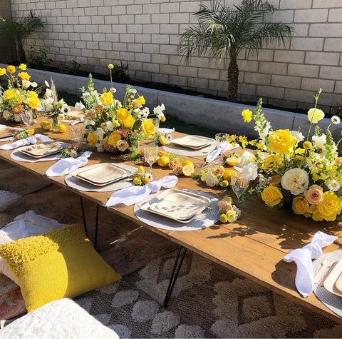 Baby shower tablescape with yellow flower centerpieces