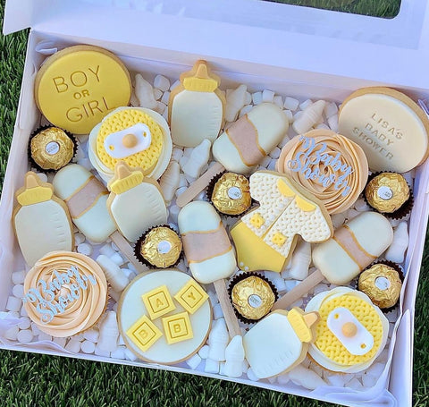 Baby shower cookies decorated in gold and yellow