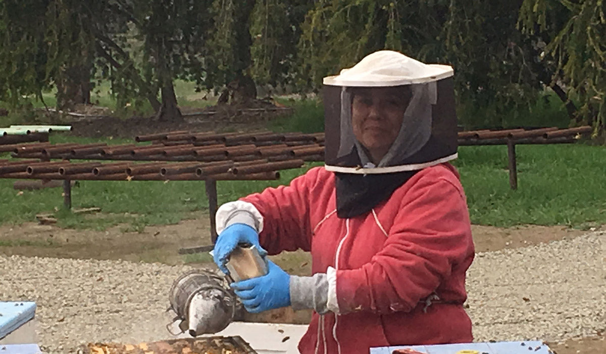 a beekeeper smiling for the camera at work