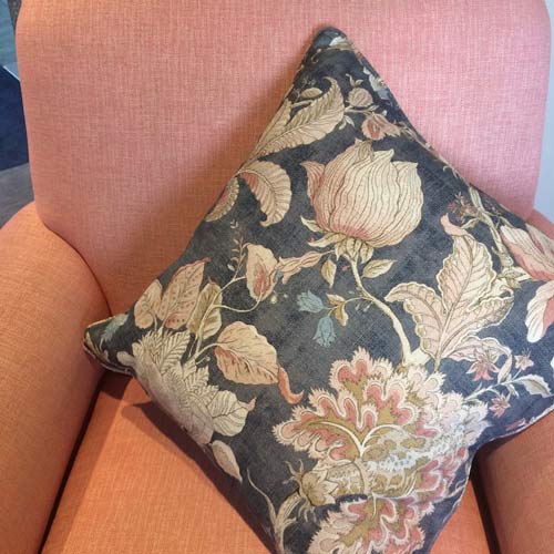pink floral and denim blue cushion on pink chair