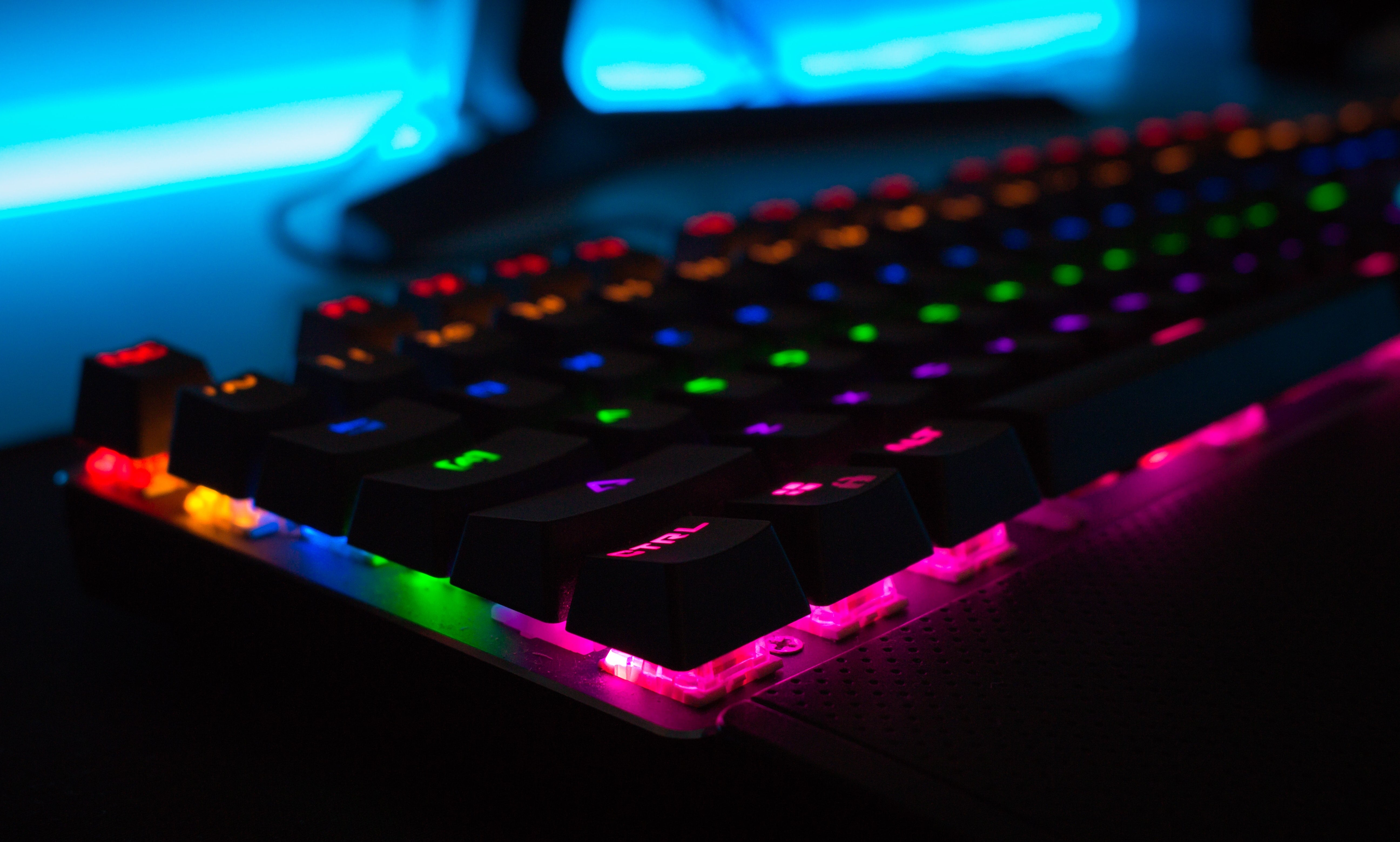 Dark keyboard with multi-colored lighting underneath