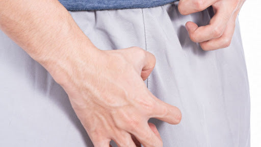 Uncomfortably placed hands of a man in the crotch area.