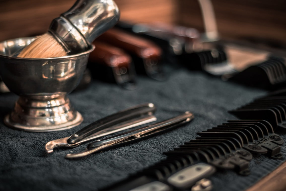 Beard styling and trimming devices on a wooden board 