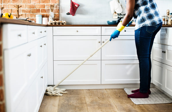 cleaning up kitchen with a mop