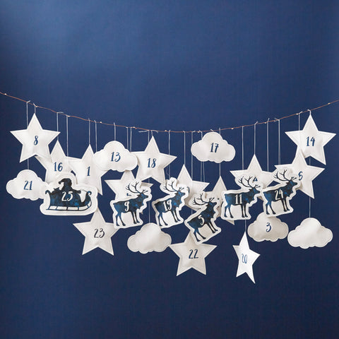 white paper pockets shaped like reindeer, stars, Santa, and clouds to form a hanging advent calendar