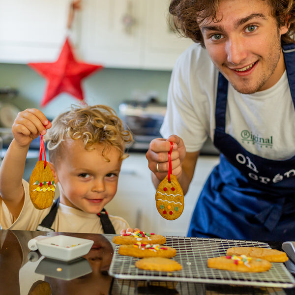 Father and son baking gingerbread baubles