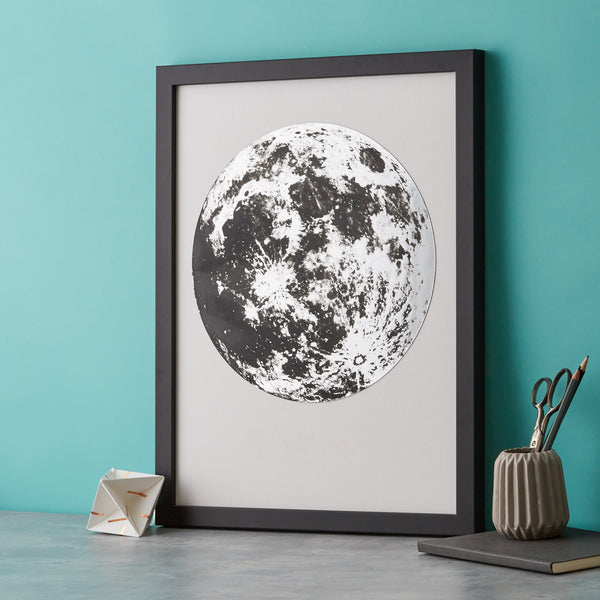 framed artwork of a silver moon on a white background.