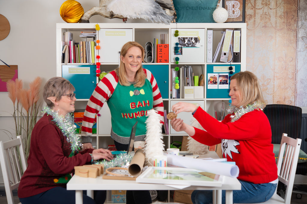 The Betsy Benn Team: Rachel, Betsy and Catherine are in Christmas jumpers around the meeting table. There is tinsel around our necks and we're wearing plastic elf ears.