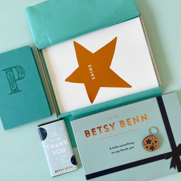 Betsy 12th Birthday box with notebook, star print, key ring and chocolate bar.