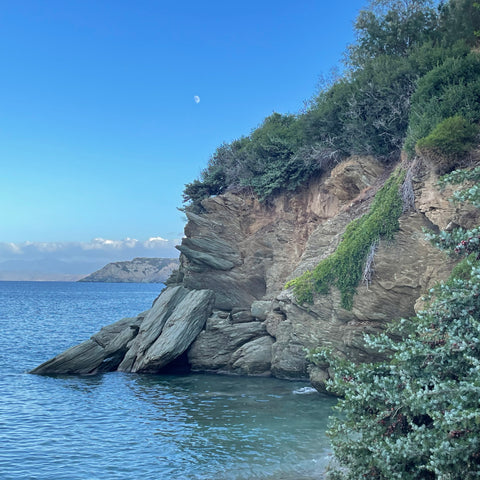 rocky outcrop in Crete with moon rising