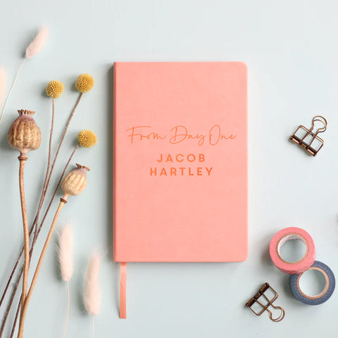 From Day One vegan leather personalised notebook gift for parents, pink on a pale grey table with washi tape