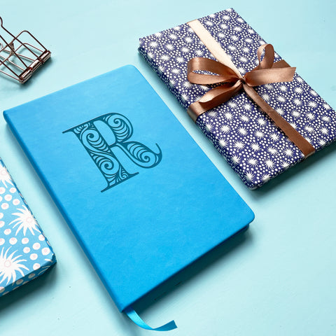 blue notebook engraved with large initial R