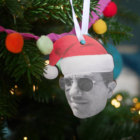 Christmas decoration featuring a mans face with a Santa Hat on