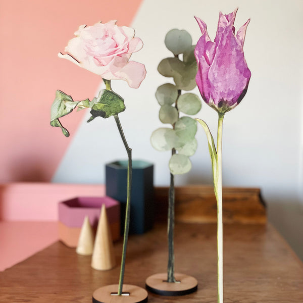purple tulip and pink rose with a stem of eucalyptus, all cut from sustainable birch plywood.