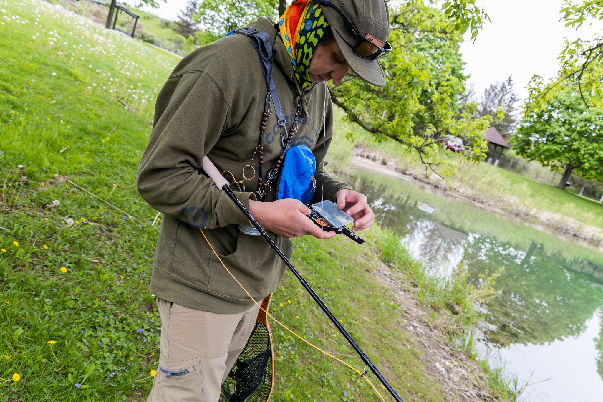 Fisherman picking out his fly fishing lure 