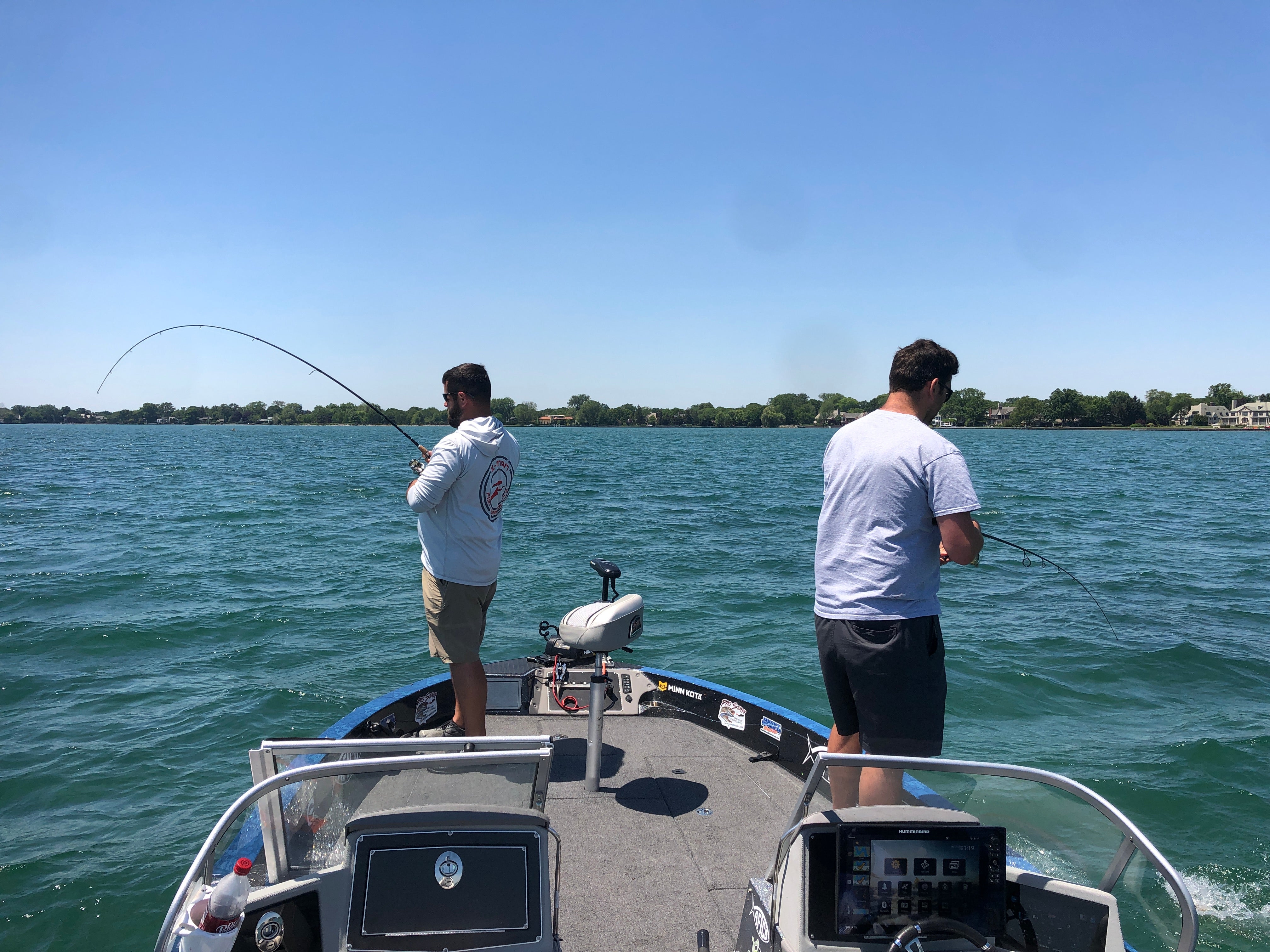 Two men fishing off a boat on Lake Erie