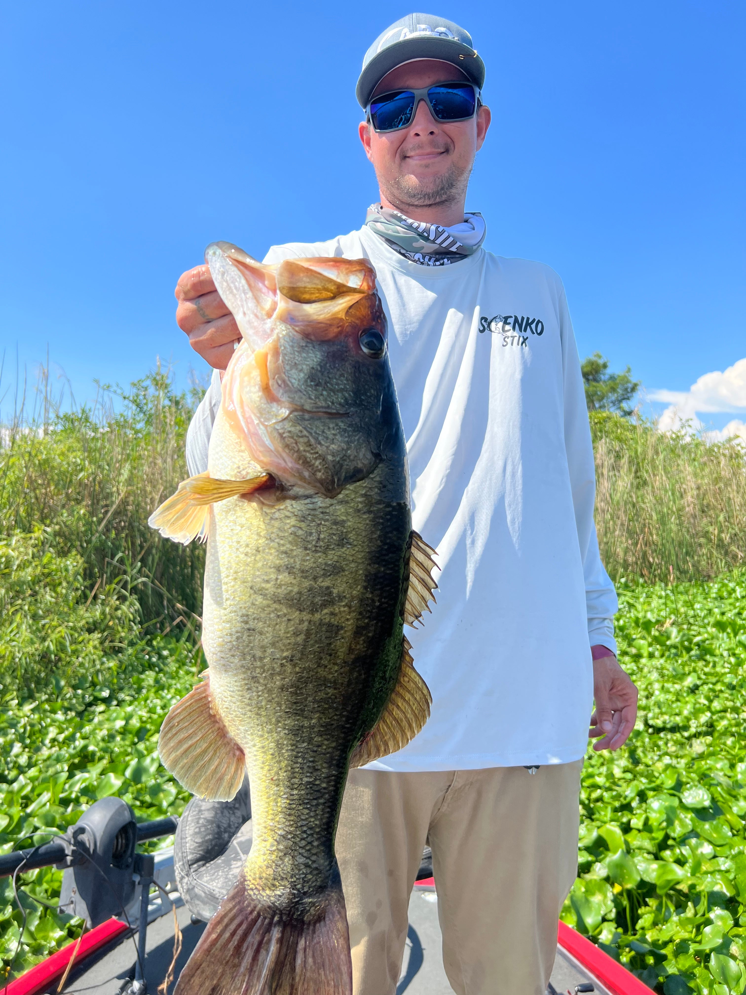Man holding up a large bass he caught