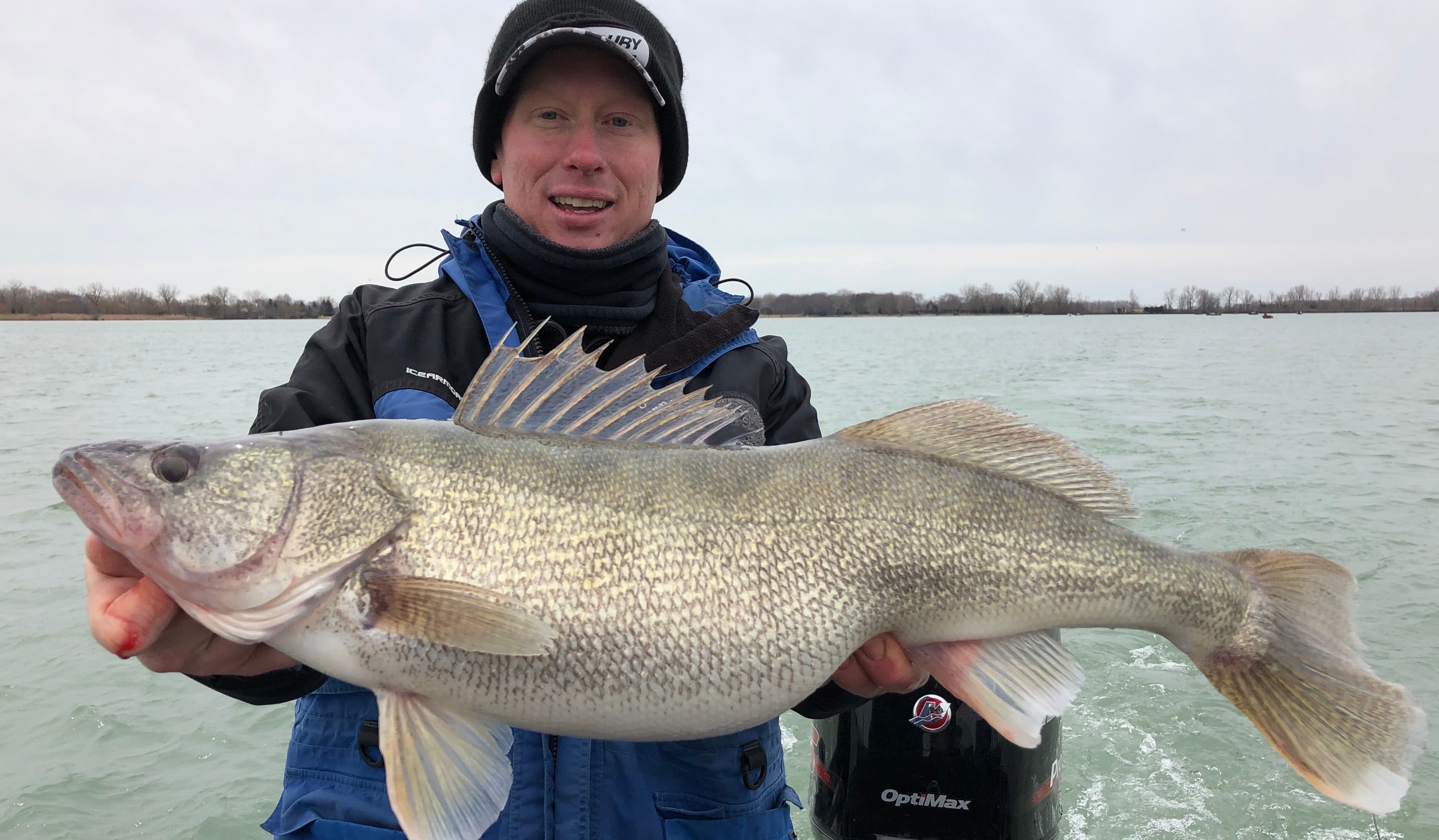 Fisherman holding up a giant walleye