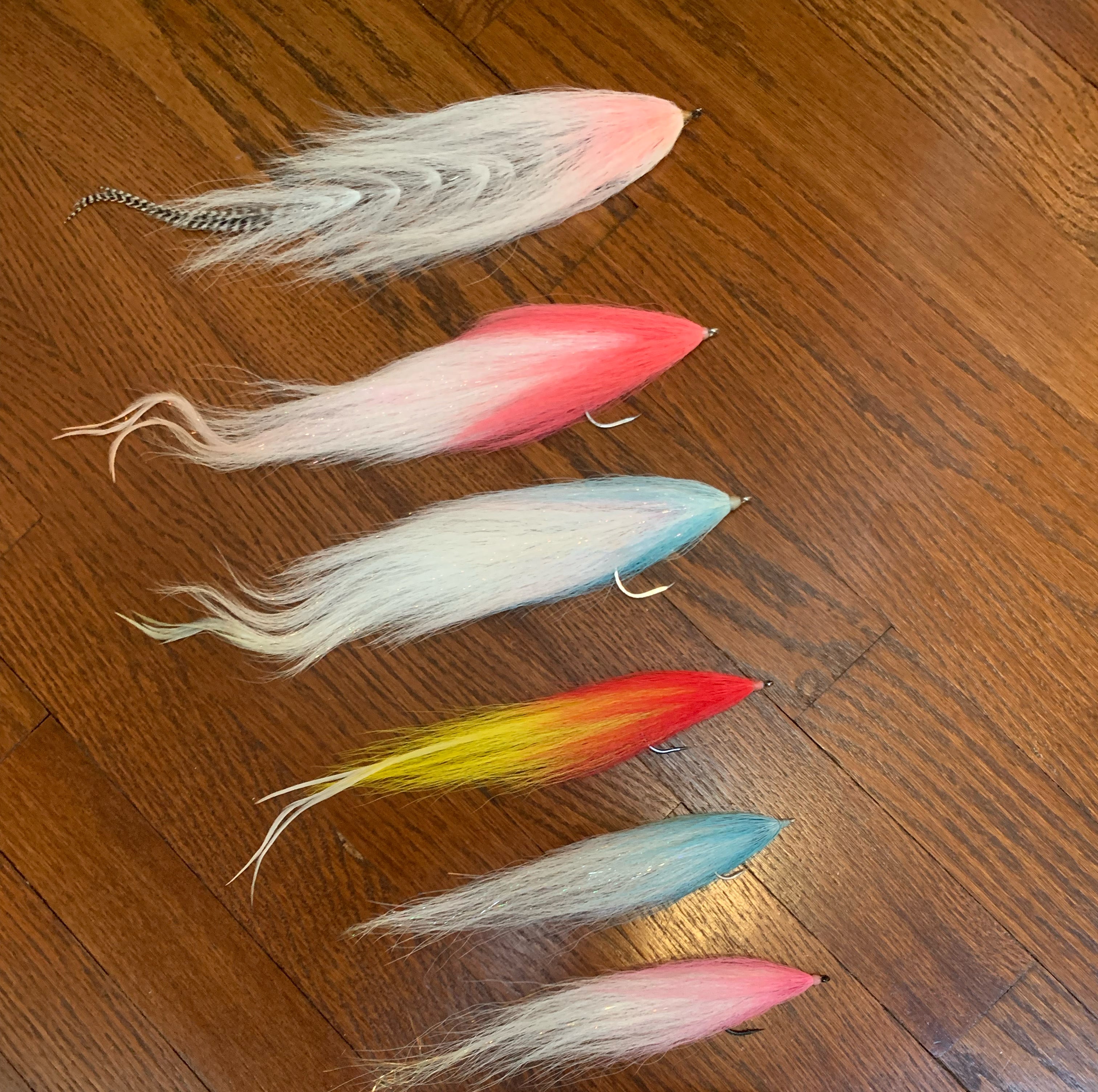 Various fly fishing flies on a wooden table