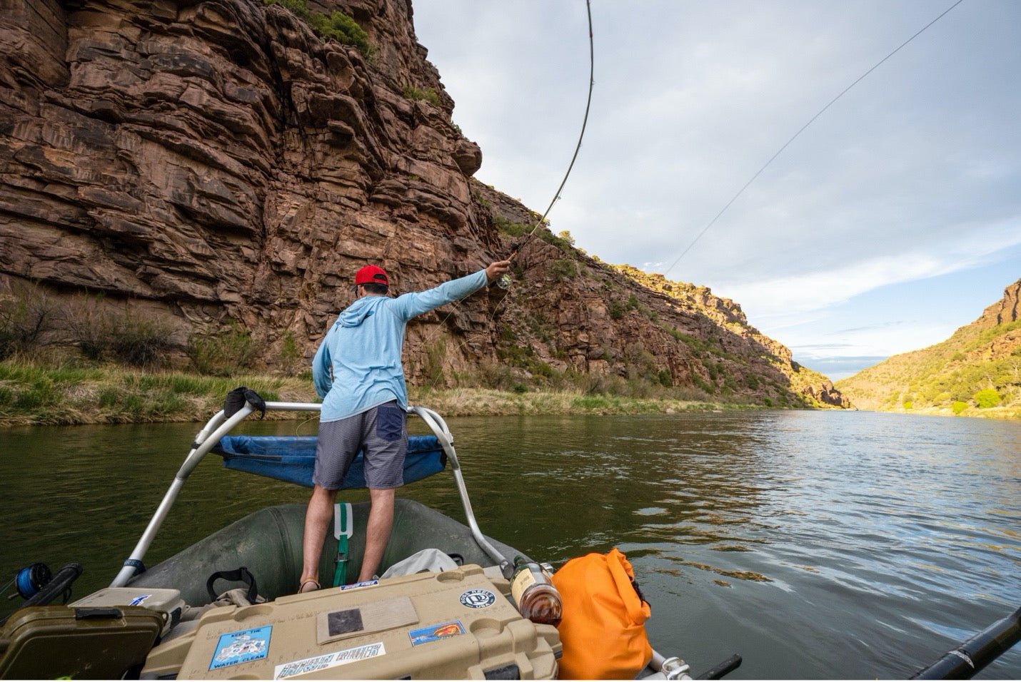 Angler on a boat casting his streamer fly line into the water