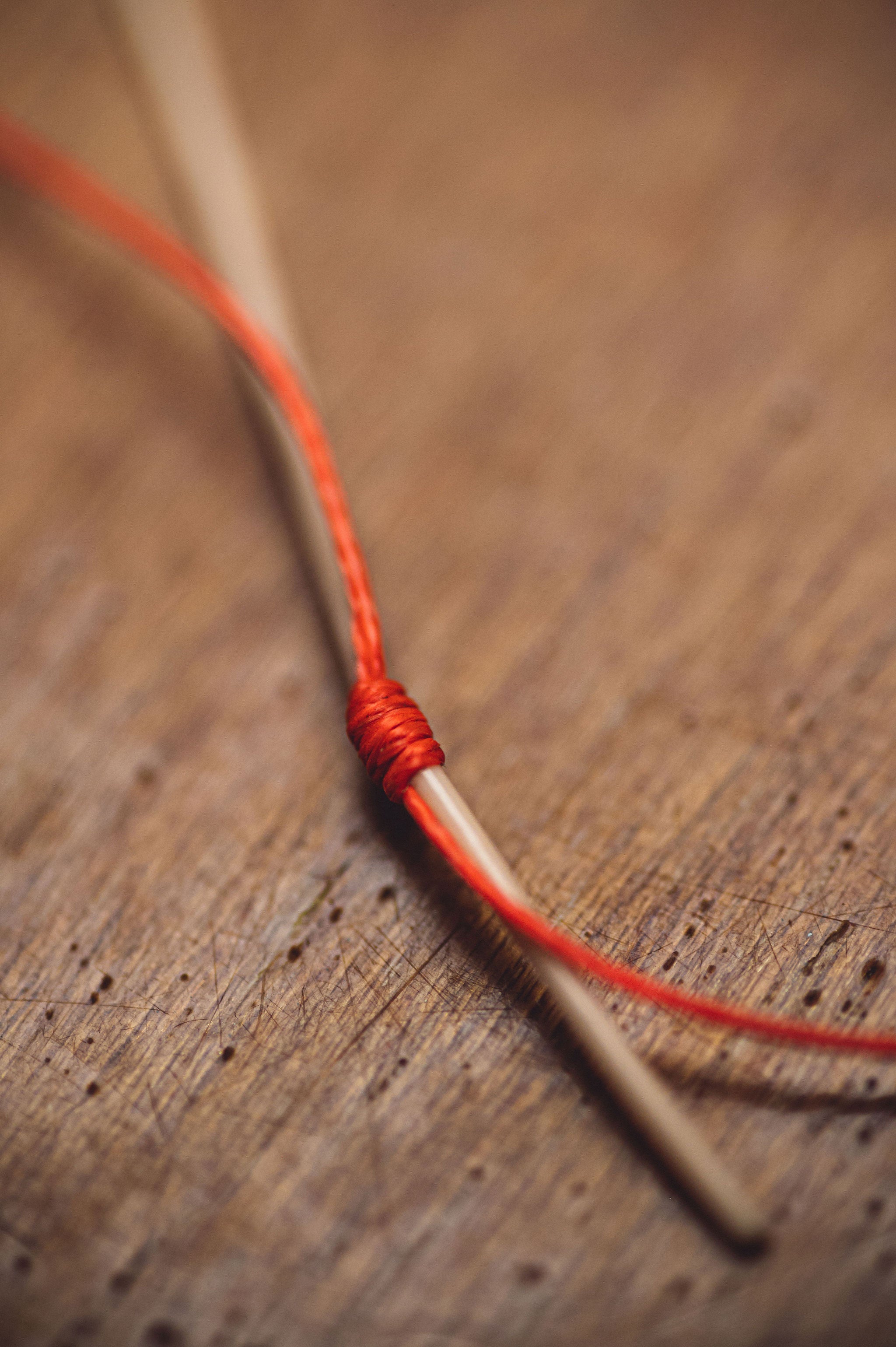 Fly fishing line knotted on a needle