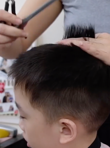 Cutting kids hair using scissor