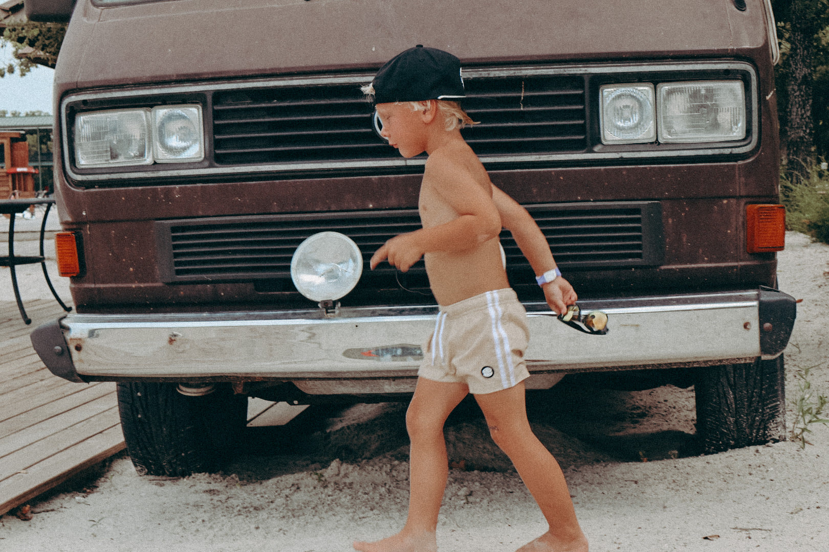 Toddler boy in Binky Bro swimsuit