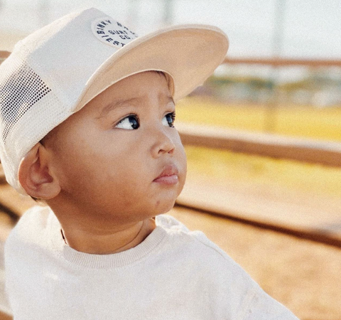 baby wearing binkybro snapback looking away