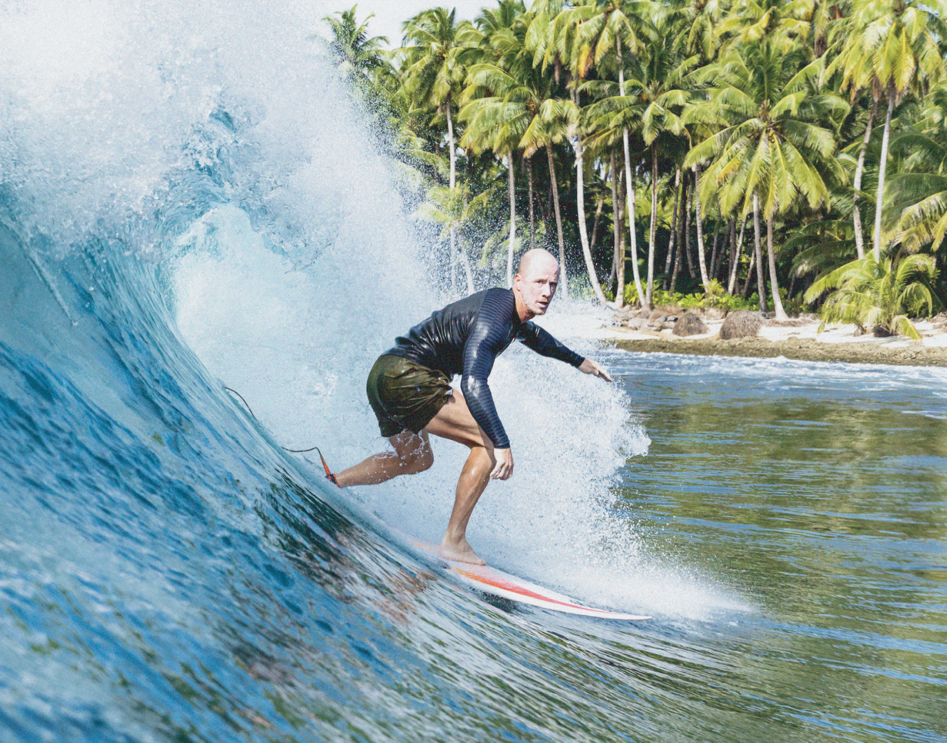 man surfing on crashing wave with binkybro swimsuit