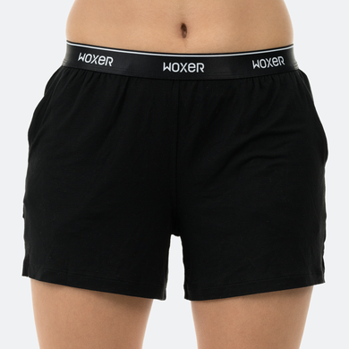 A person wearing a black pair of Woxer Dreamer boxers.