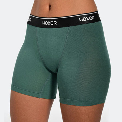 A woman wearing green women's boxershorts.