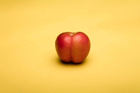 An apple that represents a heart-shaped butt.