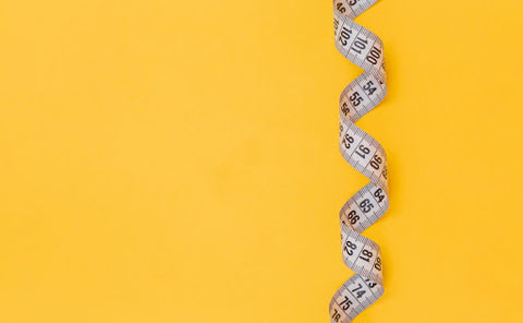 A twisted measuring tape after being used to measure a woman's waist for women's boxershorts.