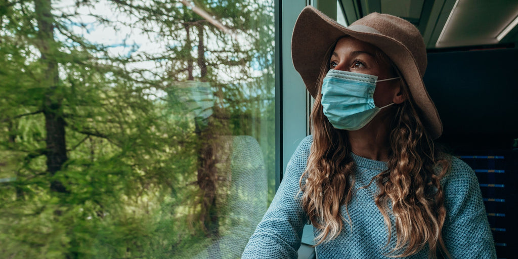 Woman travelling on bus with mask 