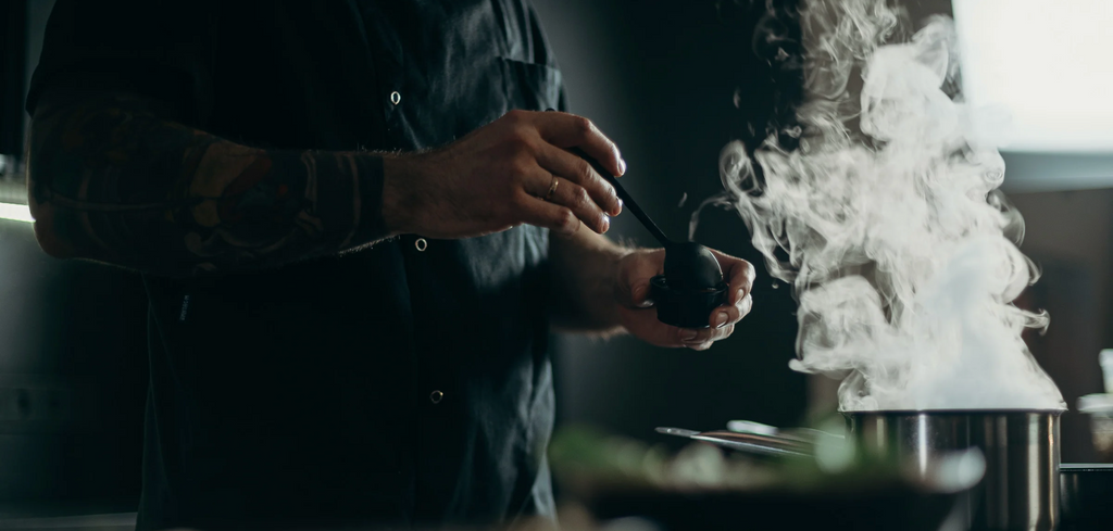 Image of cooking pot on stove, smoking 