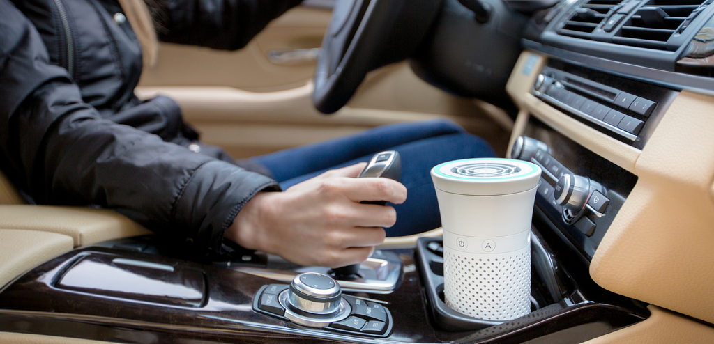 Image of WYND Plus Portable Air Purifier being used in the cup holder of a car