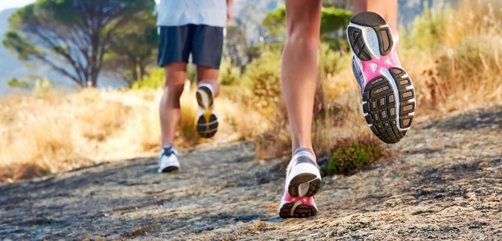 Image of two people running outdoors 