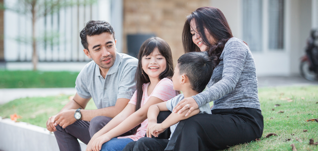 Image of family sitting outside