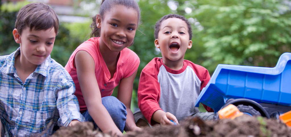 Image of children playing in dirt outside