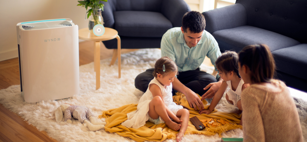 Image of family and the WYND Max Room Air Purifier in living room 