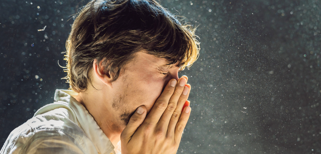 Image of man sneezing