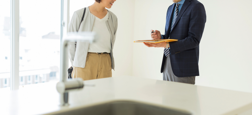 Image of woman signing insurance policy for rental property